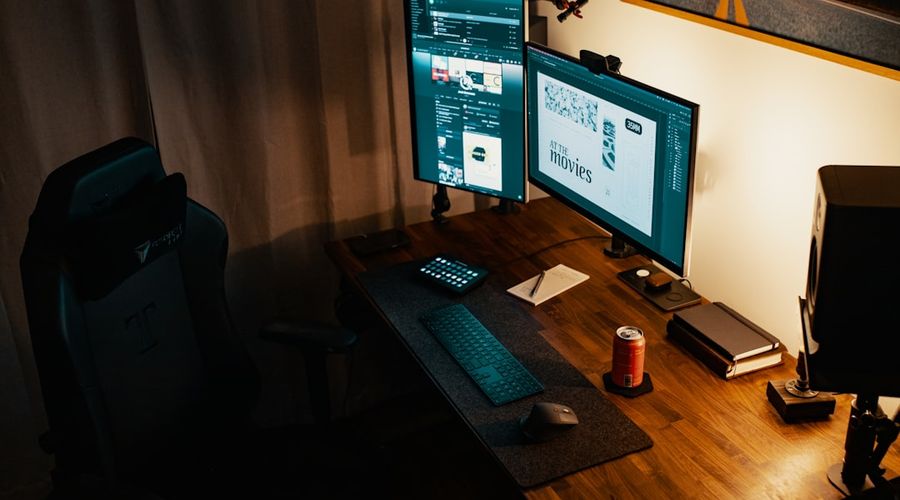 black flat screen computer monitor on brown wooden table