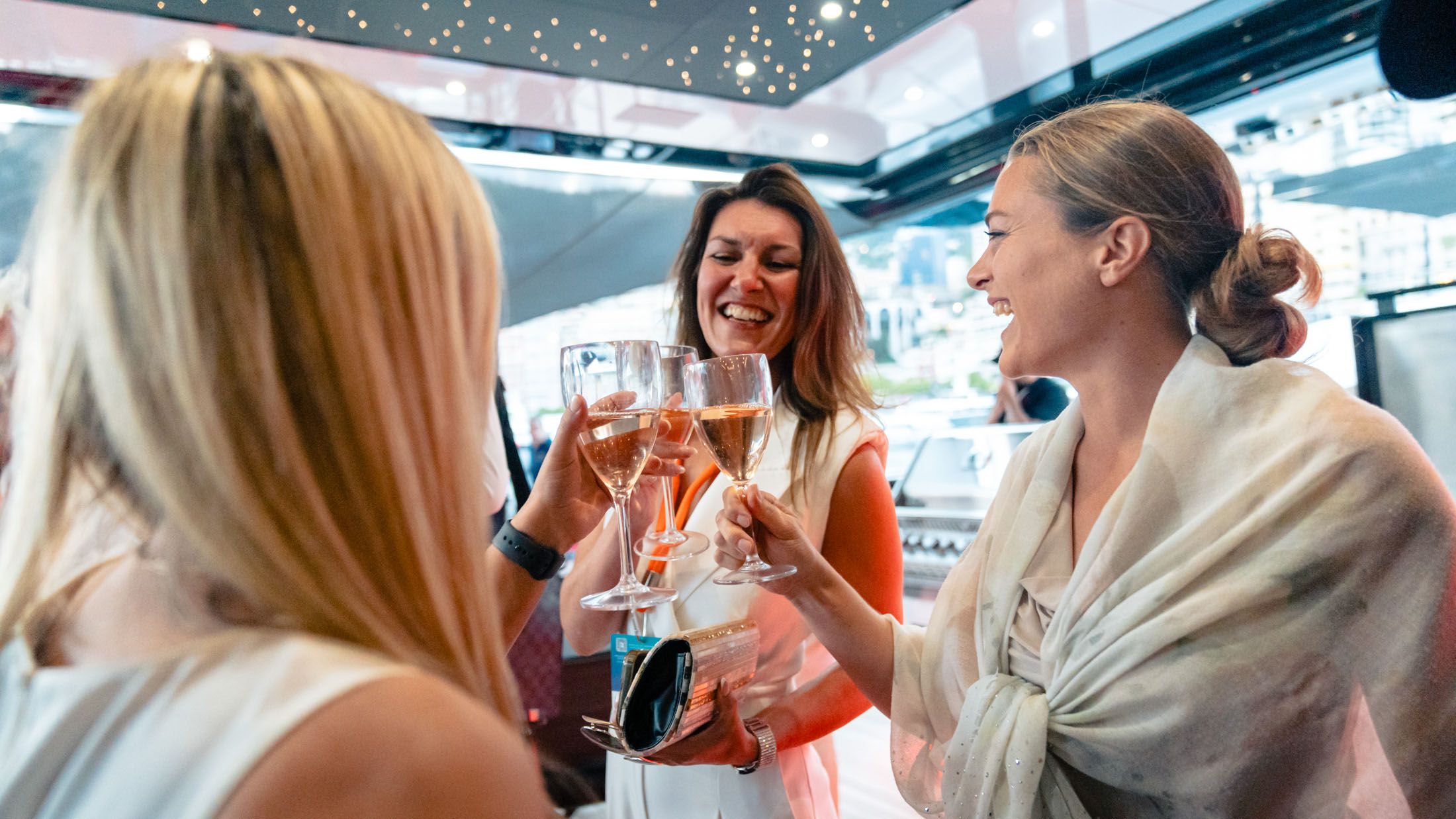 Guests toasting aboard a yacht at the Monaco Yacht Show