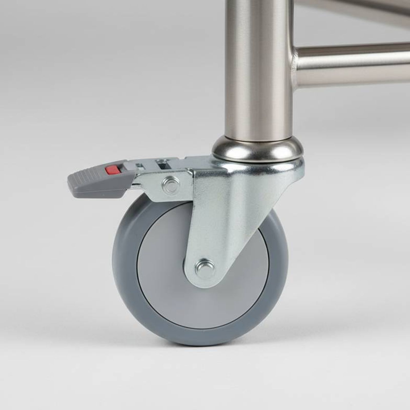 Close-up of a medical-grade caster wheel on a hospital trolley