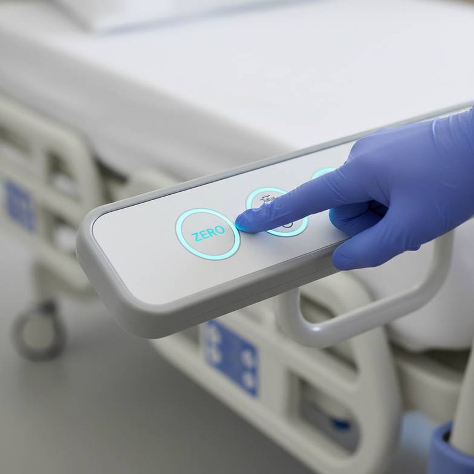 A nurse interacting with the user-friendly control panel of a modern hospital bed weighing system.