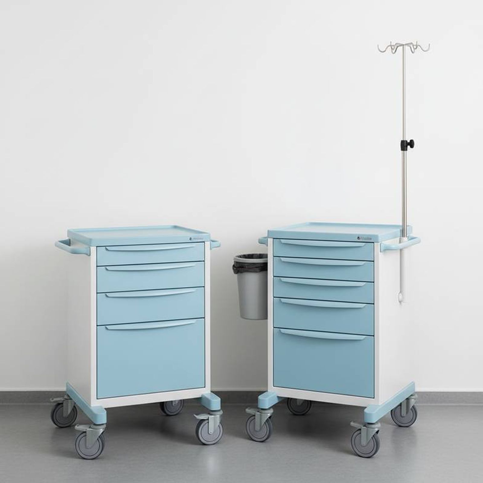Two different medicine trolleys side-by-side, one with a simple 3-drawer layout and the other with a 5-drawer mixed-height layout and multiple accessories, illustrating the challenge of comparing by photo alone.
