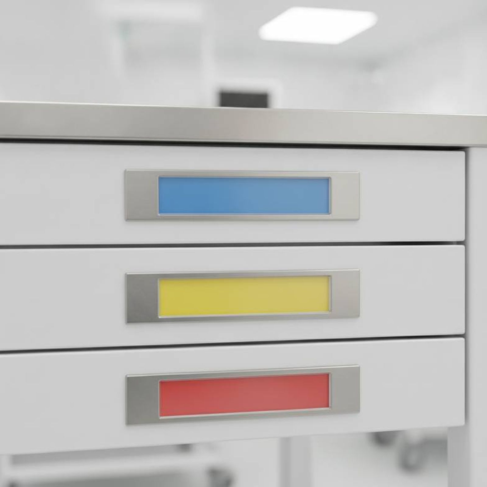 A close-up of several well-organized medical trolley label holders on a new treatment cart.