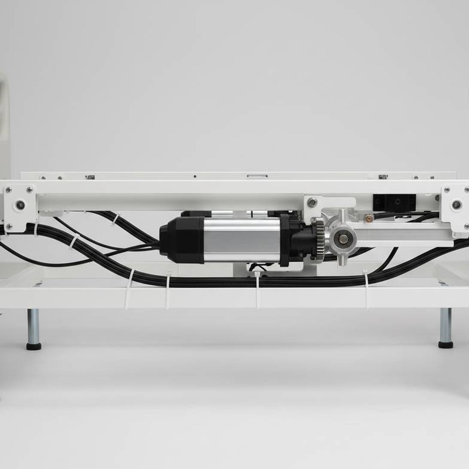 A detailed view of a hospital bed's mechanism, highlighting components relevant to hospital bed preventive maintenance.