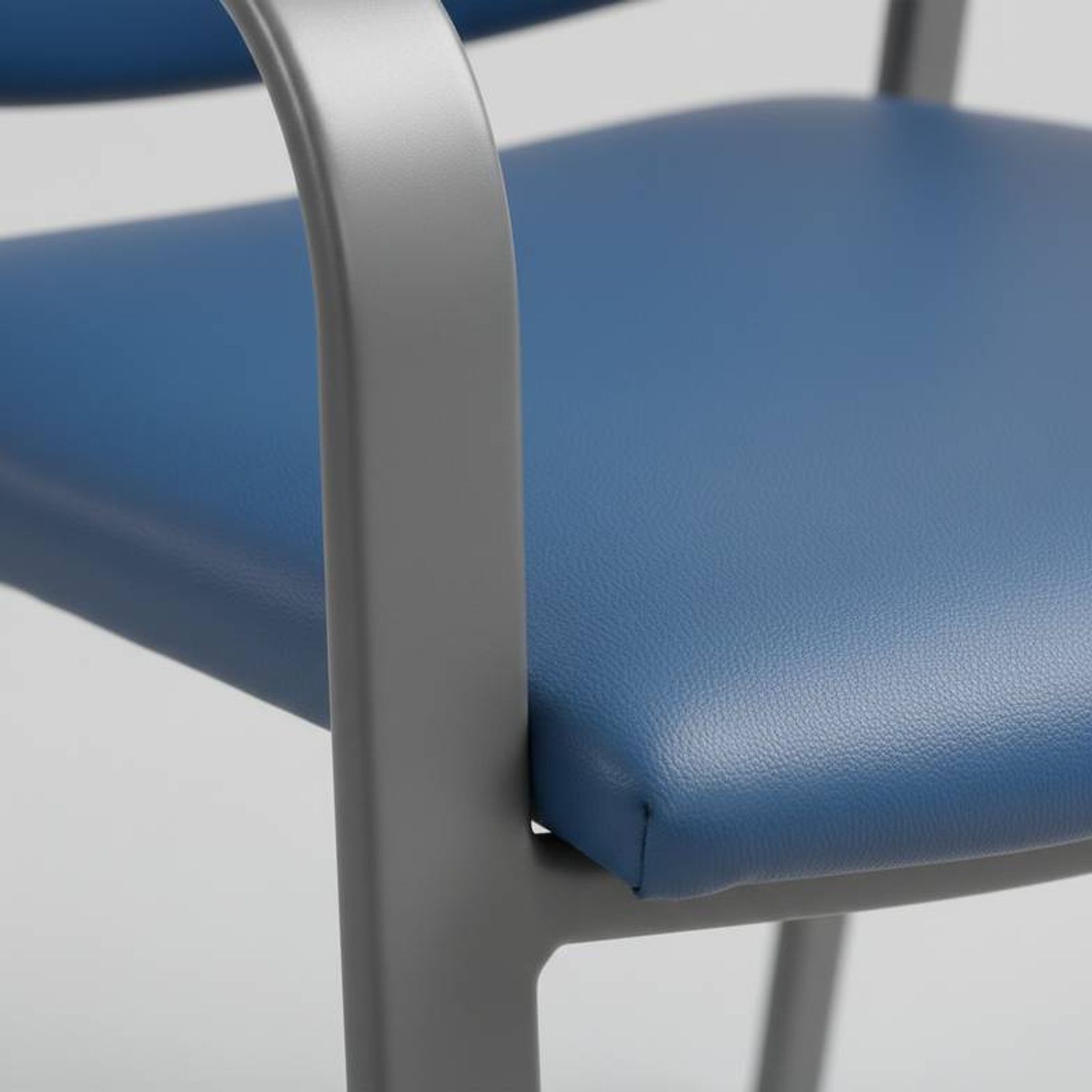 Close-up of the powder-coated steel frame and vinyl upholstery on a hospital waiting chair.