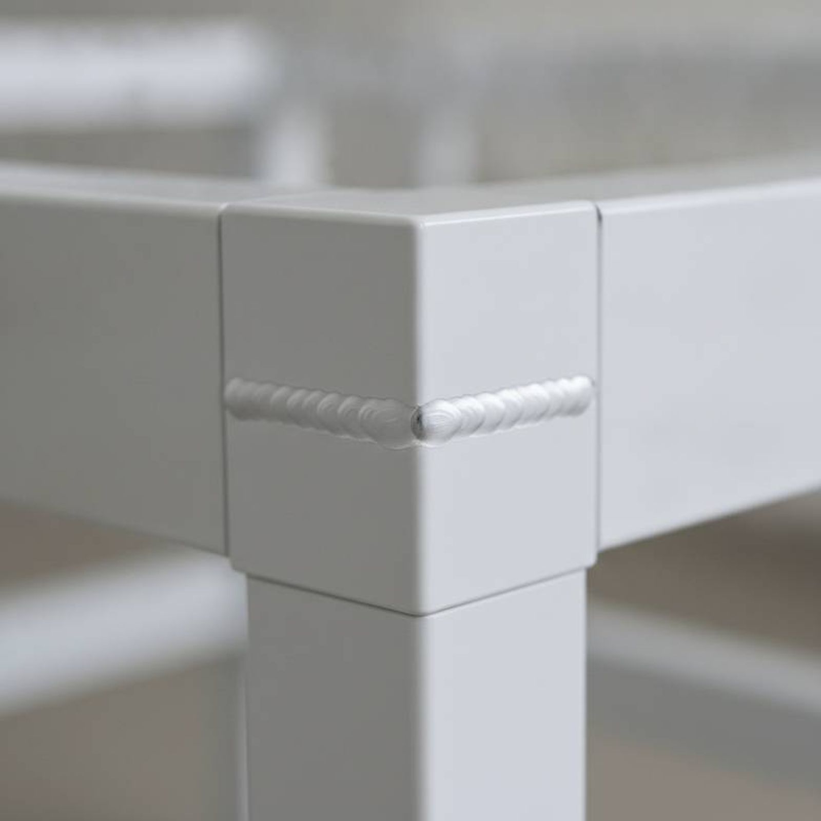 Close-up of the robust steel frame and high-quality welding on a manual hospital bed.