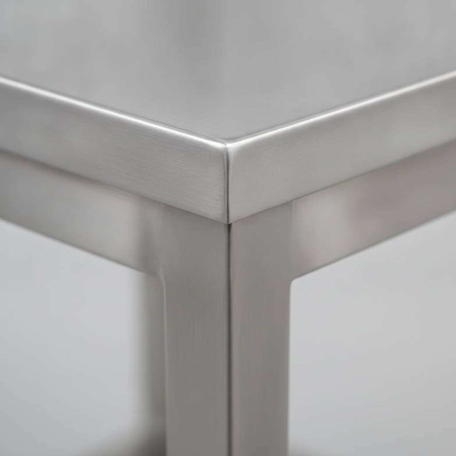 A close-up of a clean weld on a stainless steel medical trolley