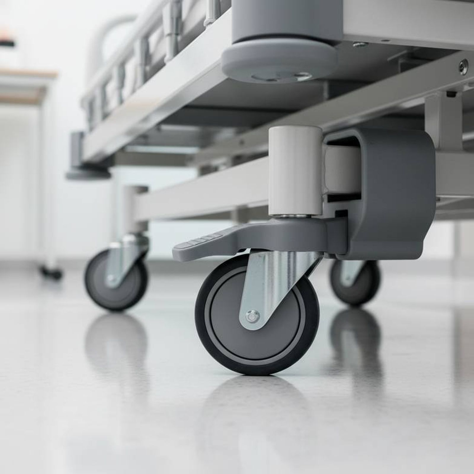 Nurse adjusting a pediatric hospital bed with one hand