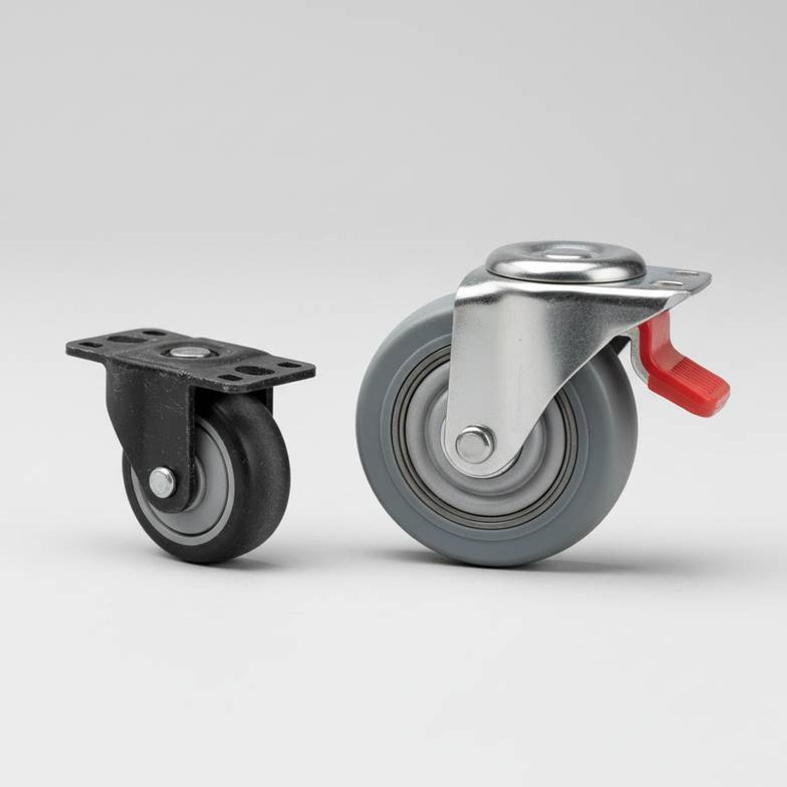 A close-up shot comparing two different trolley casters, one a basic, small wheel and the other a larger, more robust medical-grade caster with a brake.