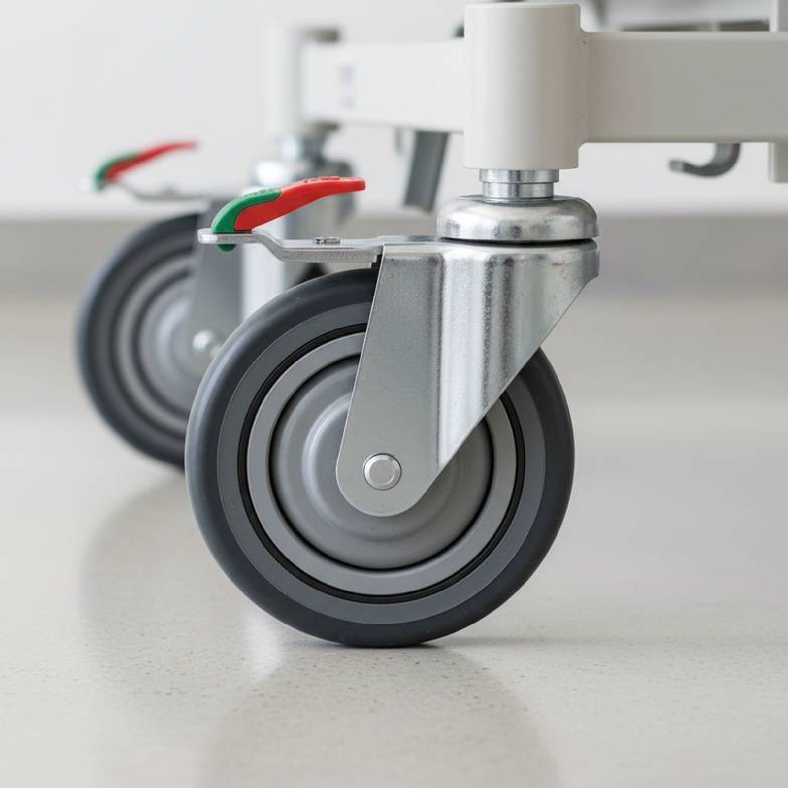 Close-up of a hospital bed's durable caster and braking system, a critical factor for the hospital bed replacement cycle
