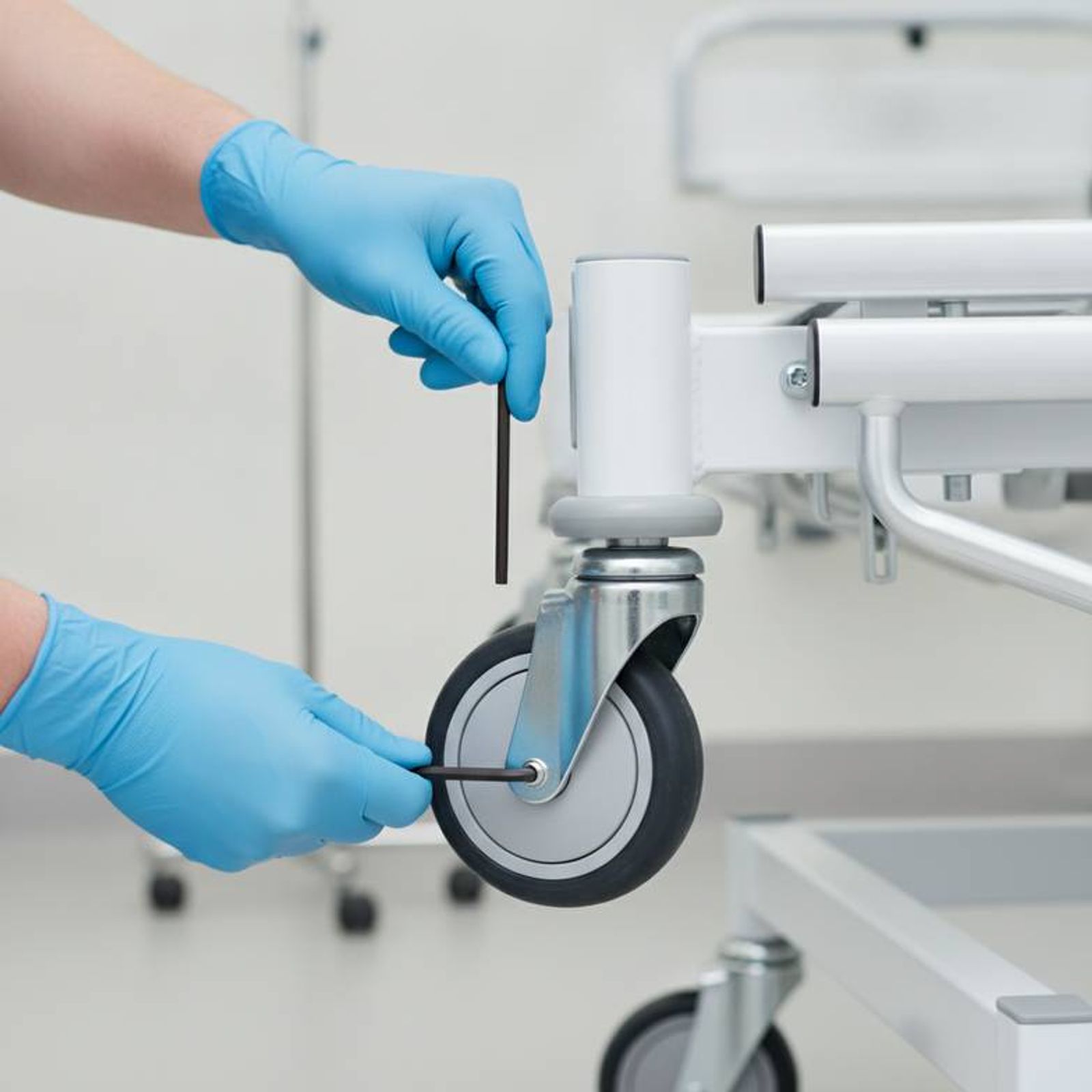 A local technician replacing a part on a hospital bed, a key part of after-sales support for imported hospital furniture.