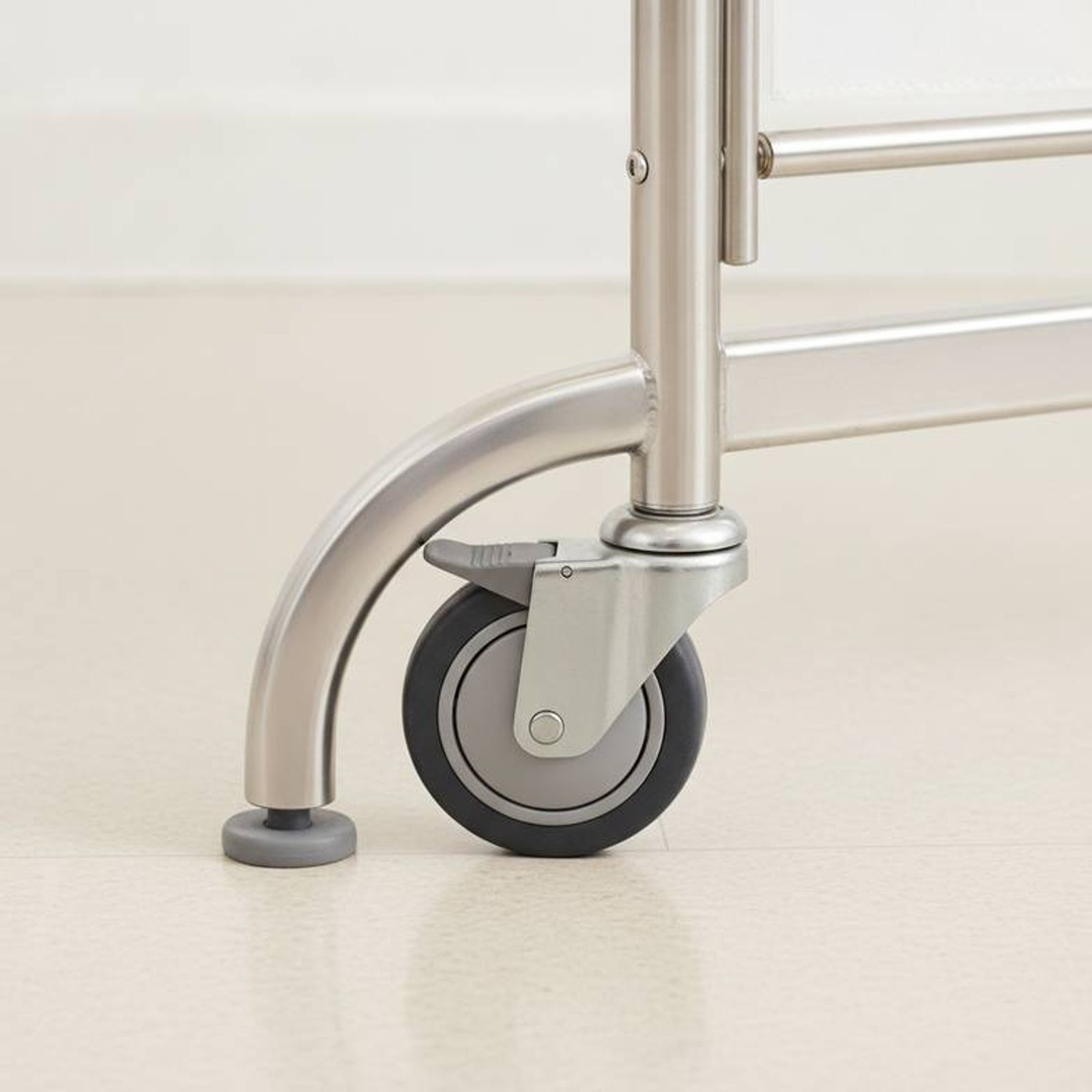 A close-up image showing the base and locking caster of a mobile hospital screen.