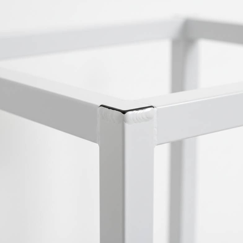 A close-up view of a high-quality, smooth weld on the steel frame of a medical trolley.