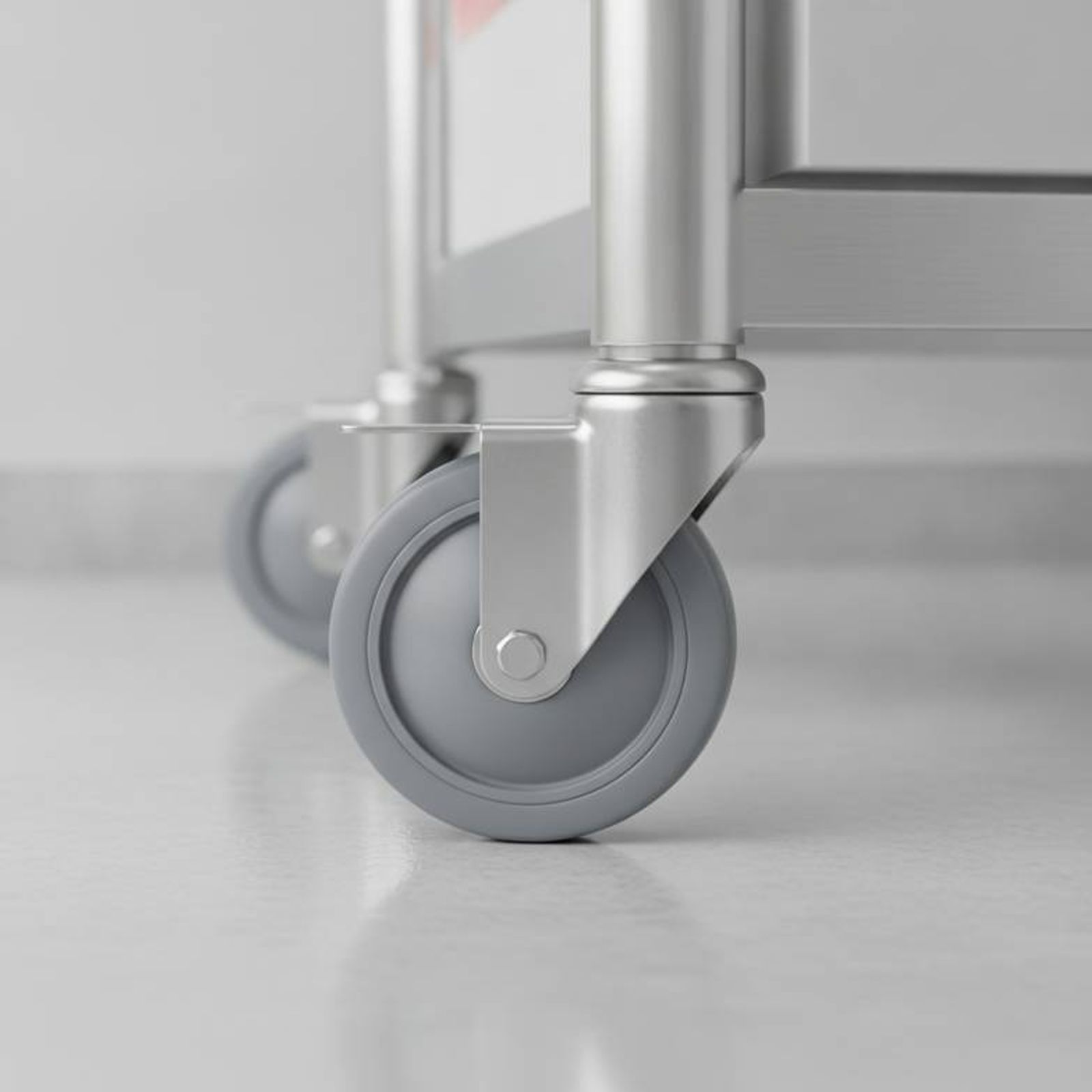 Close-up of a medical-grade silent caster on a hospital medical cart