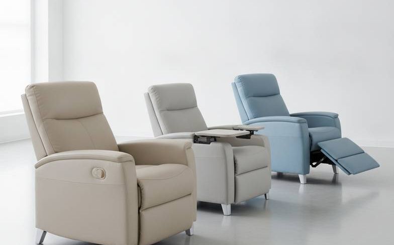A collection of medical recliners for nursing homes in a well-lit room