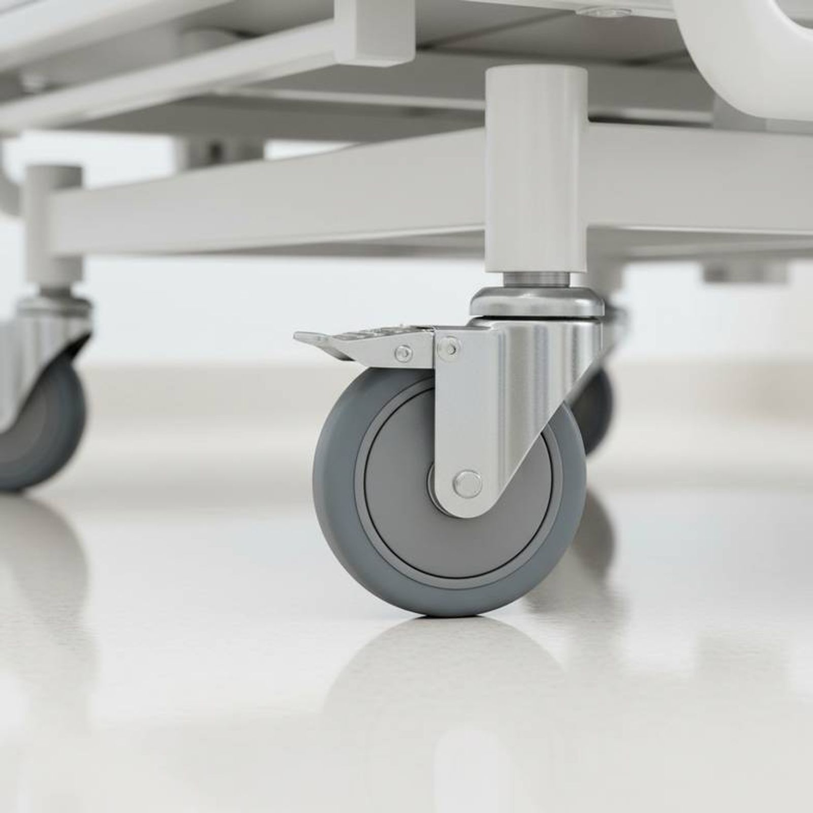 Close-up of a high-quality caster on a hospital bed from a patient room furniture package.