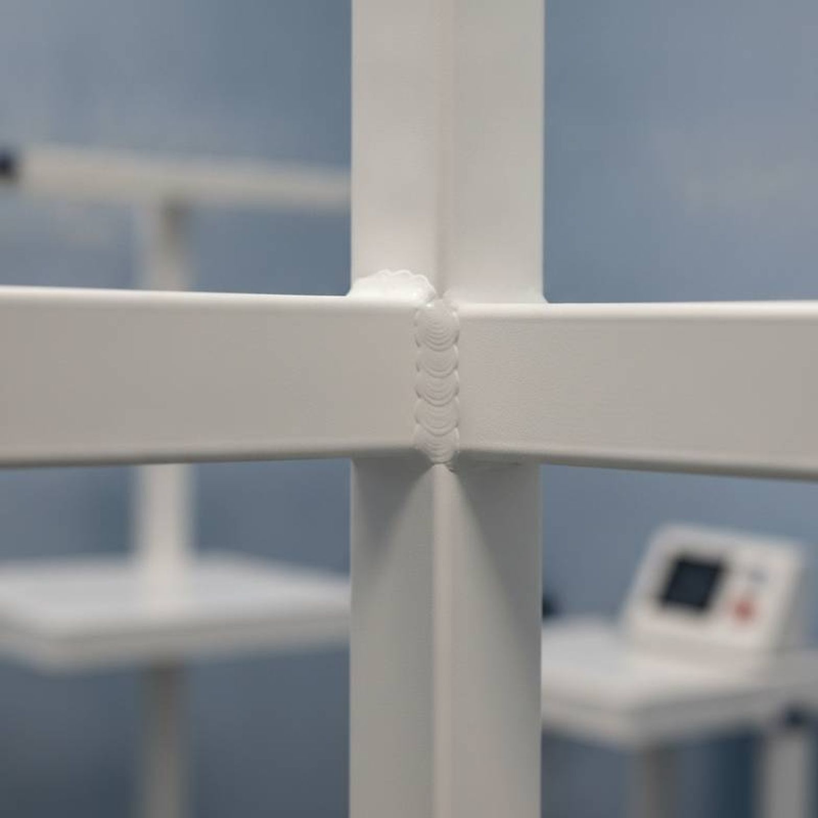 A close-up photo of a clean, strong weld on a steel furniture frame, illustrating durable construction.