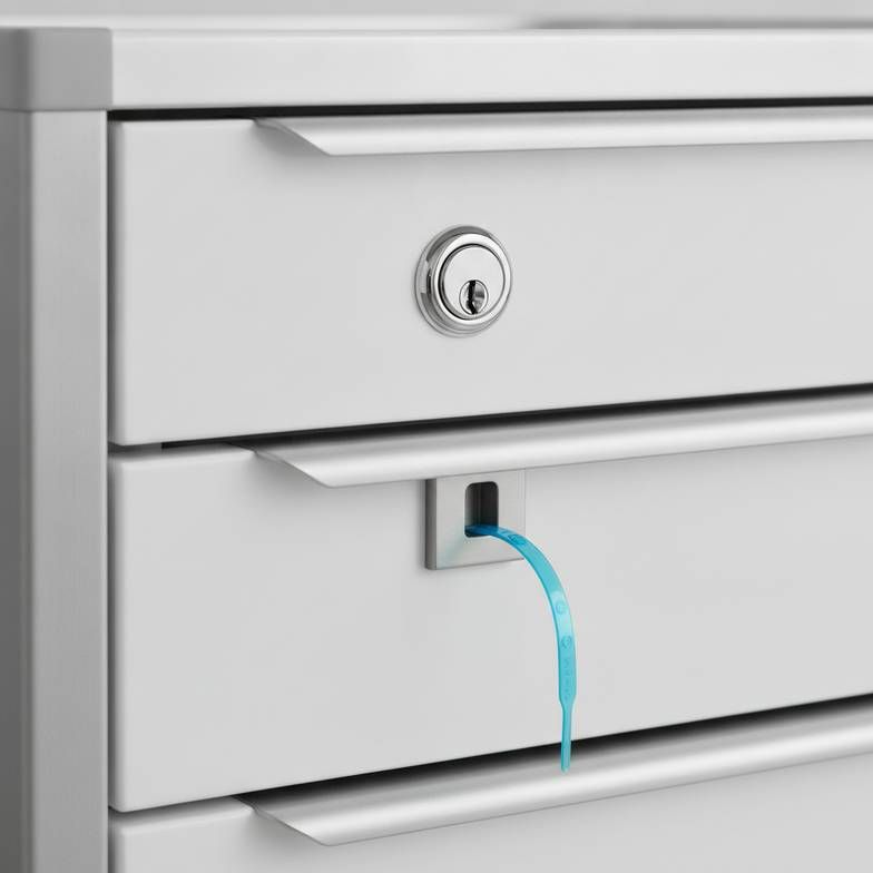 A close-up of different locking mechanisms on a medical cart drawer.