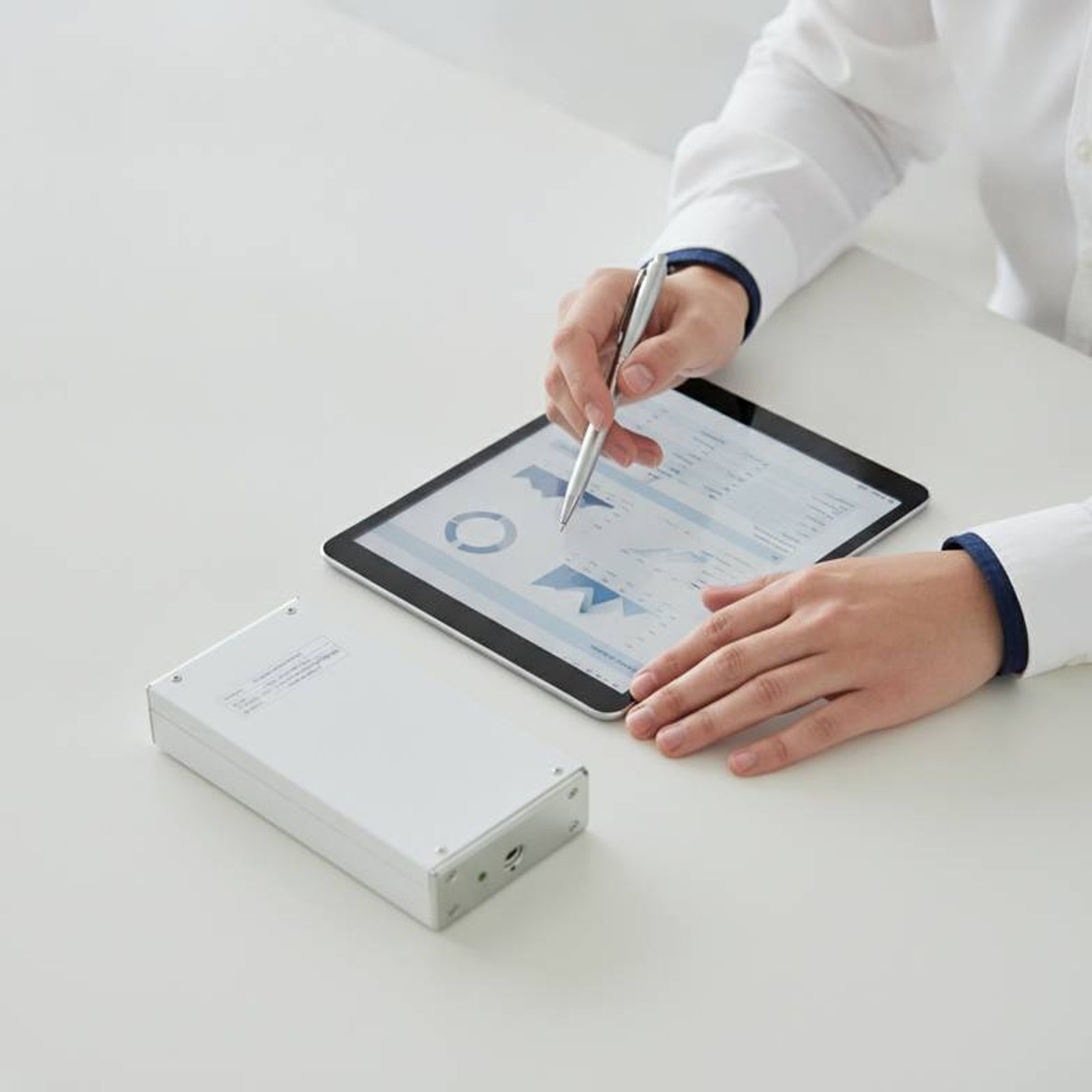 A healthcare procurement manager carefully reviewing a technical datasheet for a hospital bed battery backup to verify its specifications against tender require