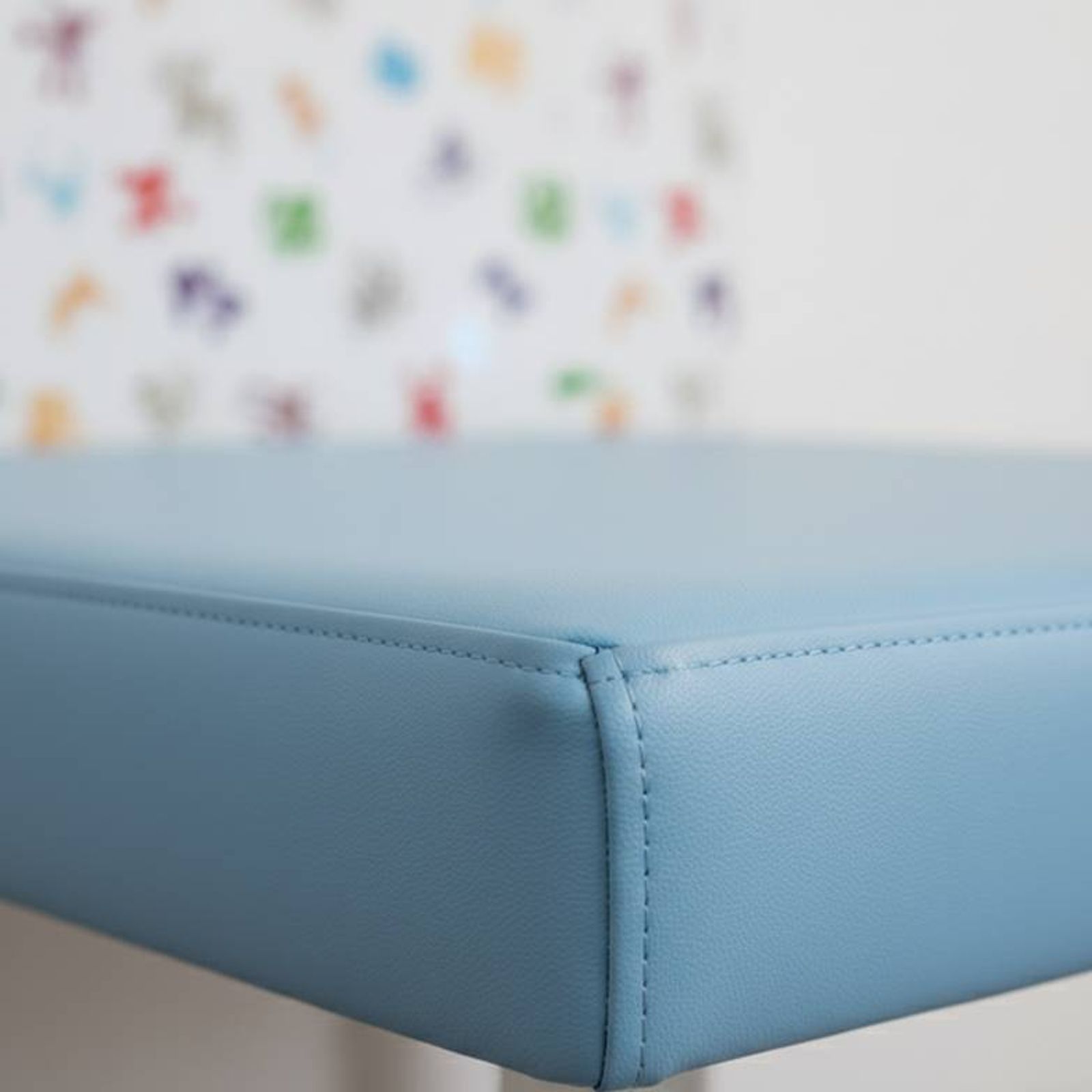 Close-up of durable, easy-to-clean pediatric outpatient room furniture with rounded corners, highlighting safety and material quality.