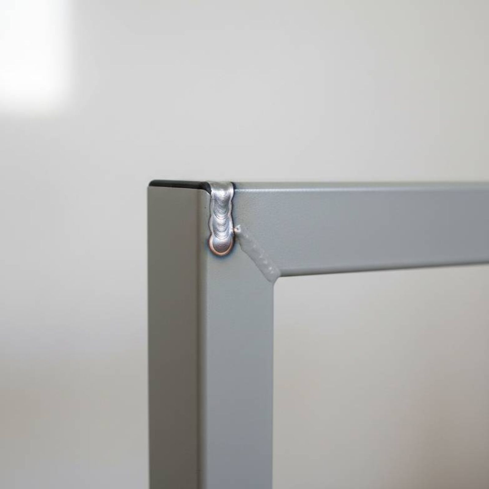 A detailed shot showing a clean, strong weld on the joint of a hospital waiting chair frame.