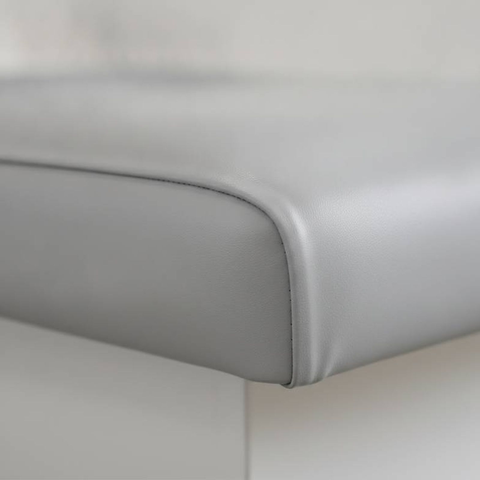 A seamless upholstery cushion on a medical exam table, designed for easy cleaning and infection control