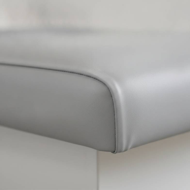 A seamless upholstery cushion on a medical exam table, designed for easy cleaning and infection control