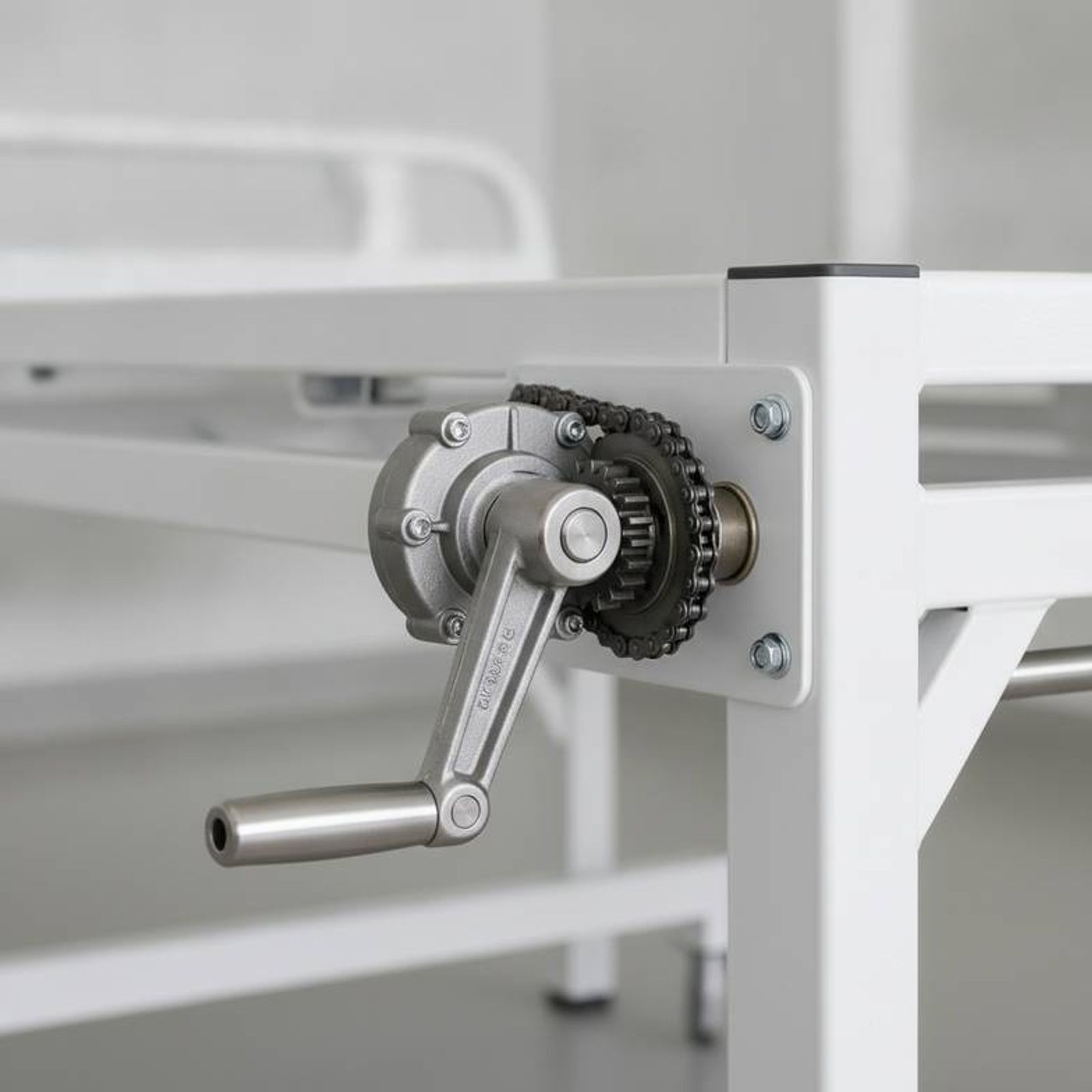 A close-up of a robust manual crank mechanism on a hospital bed, suitable for African rural clinic projects.