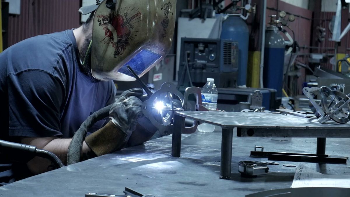 Welder fabricating metal components in the Renaissance shop