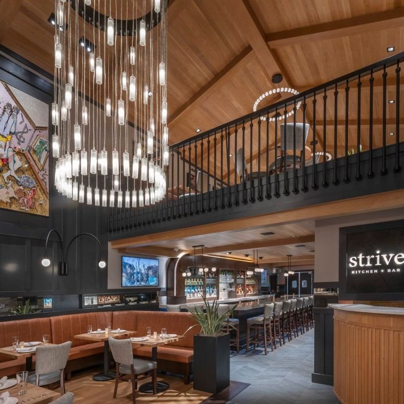 Step inside Strive Kitchen & Bar, where our massive chandelier and sleek wall sconces bring dramatic lighting and elevated style to every corner of the space…