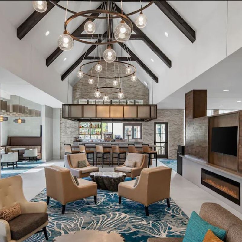 The stunning glass ceiling light fixtures in this space add a sense of warmth, elegance, and modern charm, creating a welcoming ambiance for guests. Their de…
