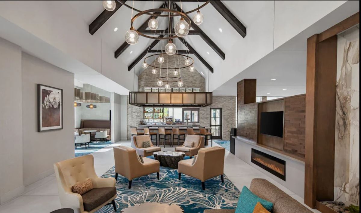 The stunning glass ceiling light fixtures in this space add a sense of warmth, elegance, and modern charm, creating a welcoming ambiance for guests. Their de…