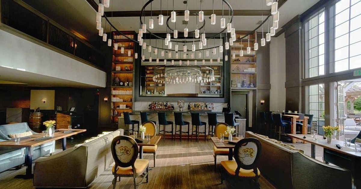 This huge custom fixture spans 17' across and 7' high! Featuring Gun Metal Powder Coat and Frosted White Acrylic Cylinder Shades. Custom made here in Roanoke…