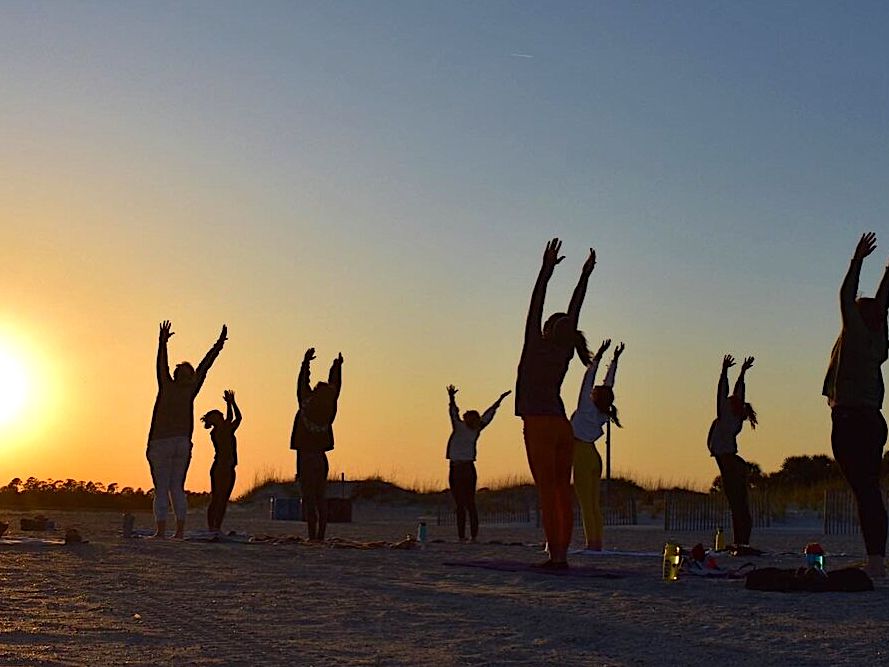 A Group of Women Doing Sunrise Yoga on Tybee Island