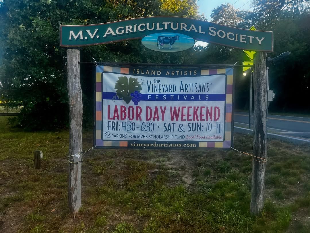 A colorful banner outside the Martha’s Vineyard Agricultural Society welcomes visitors to the Vineyard Artisans Festival over Labor Day weekend. The sign highlights local artists, handmade goods, and the island’s strong sense of community.