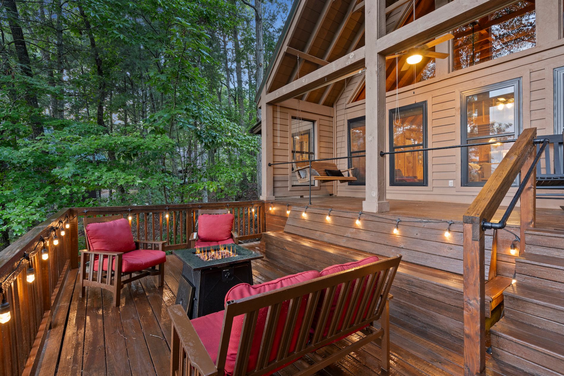 Back Deck of Luxury Suches Cabin Rental with Chairs, Lights & a Fire Pit