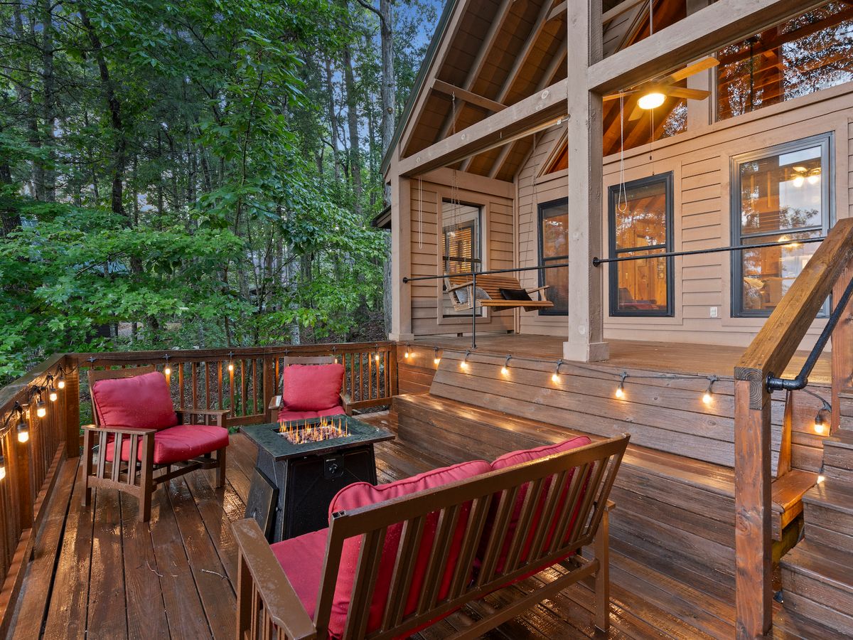 Back Deck of Luxury Suches Cabin Rental with Chairs, Lights & a Fire Pit
