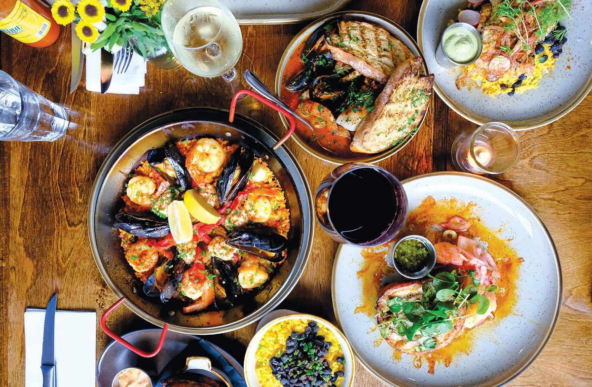 Beautifully plated desserts arranged on white dishes inside a professional kitchen. Each plate features a golden tart paired with sauce and garnish, showing the care that goes into every dish. Restaurants like Casa Del Cabo are known for creative presentation and refined dining experiences.