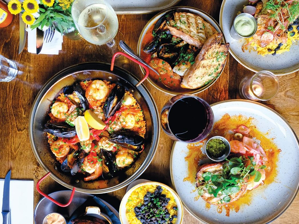 Beautifully plated desserts arranged on white dishes inside a professional kitchen. Each plate features a golden tart paired with sauce and garnish, showing the care that goes into every dish. Restaurants like Casa Del Cabo are known for creative presentation and refined dining experiences.