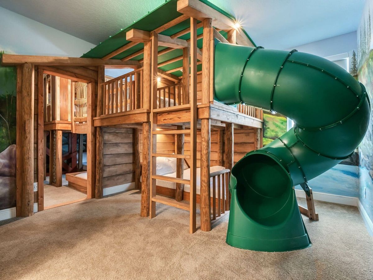 Playground with green slide inside of vacation rental in Florida