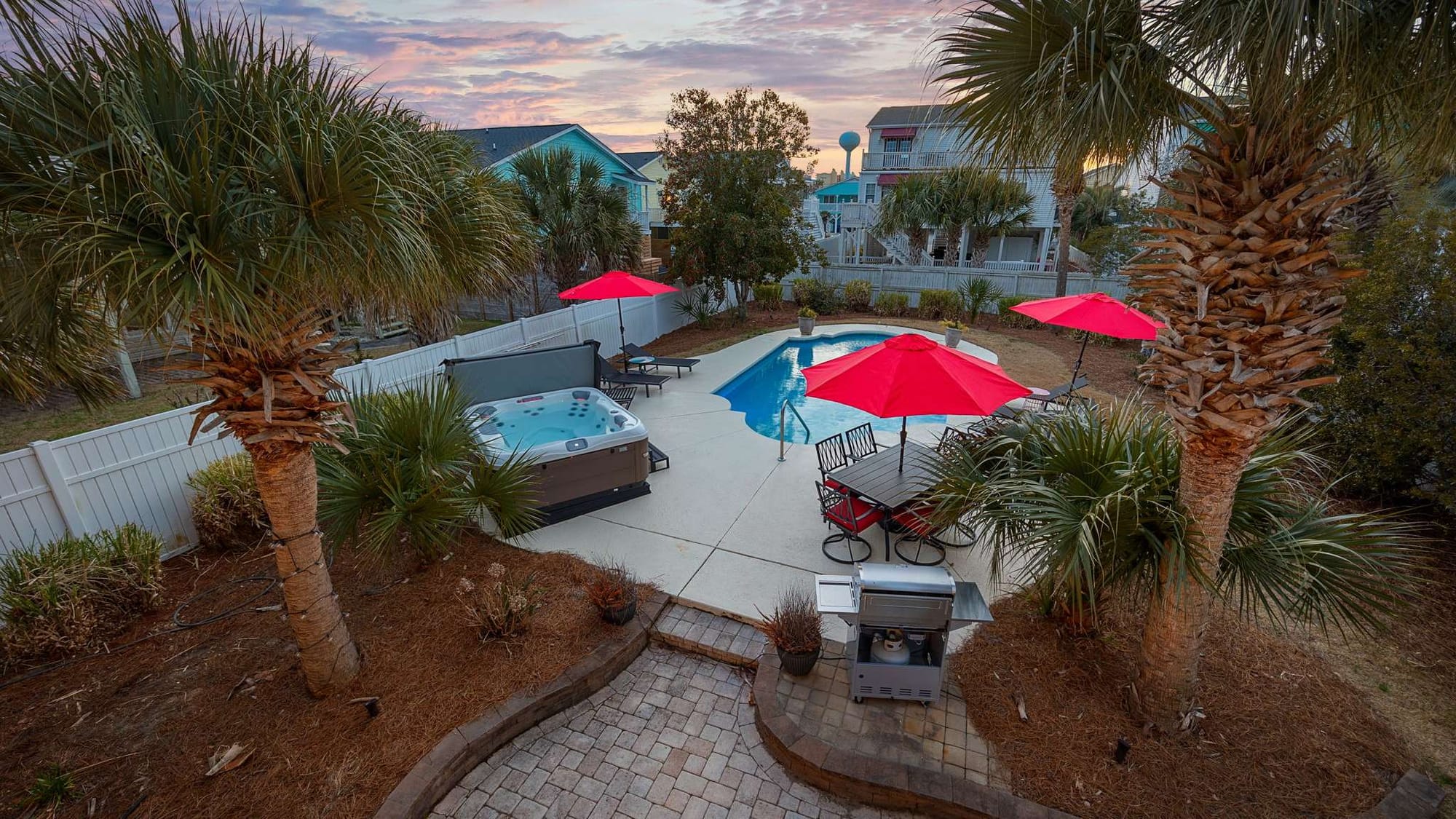 This coastal gem features a winding pool surrounded by colorful chairs and palm trees, offering the perfect setup for sun-soaked afternoons. Its mix of comfort and fun captures the essence of a true beach vacation.