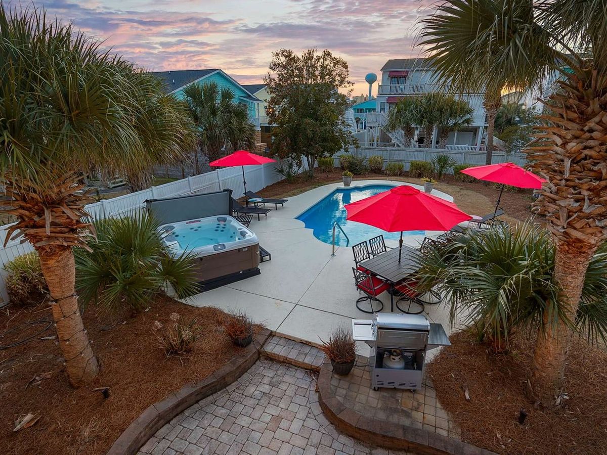 This coastal gem features a winding pool surrounded by colorful chairs and palm trees, offering the perfect setup for sun-soaked afternoons. Its mix of comfort and fun captures the essence of a true beach vacation.