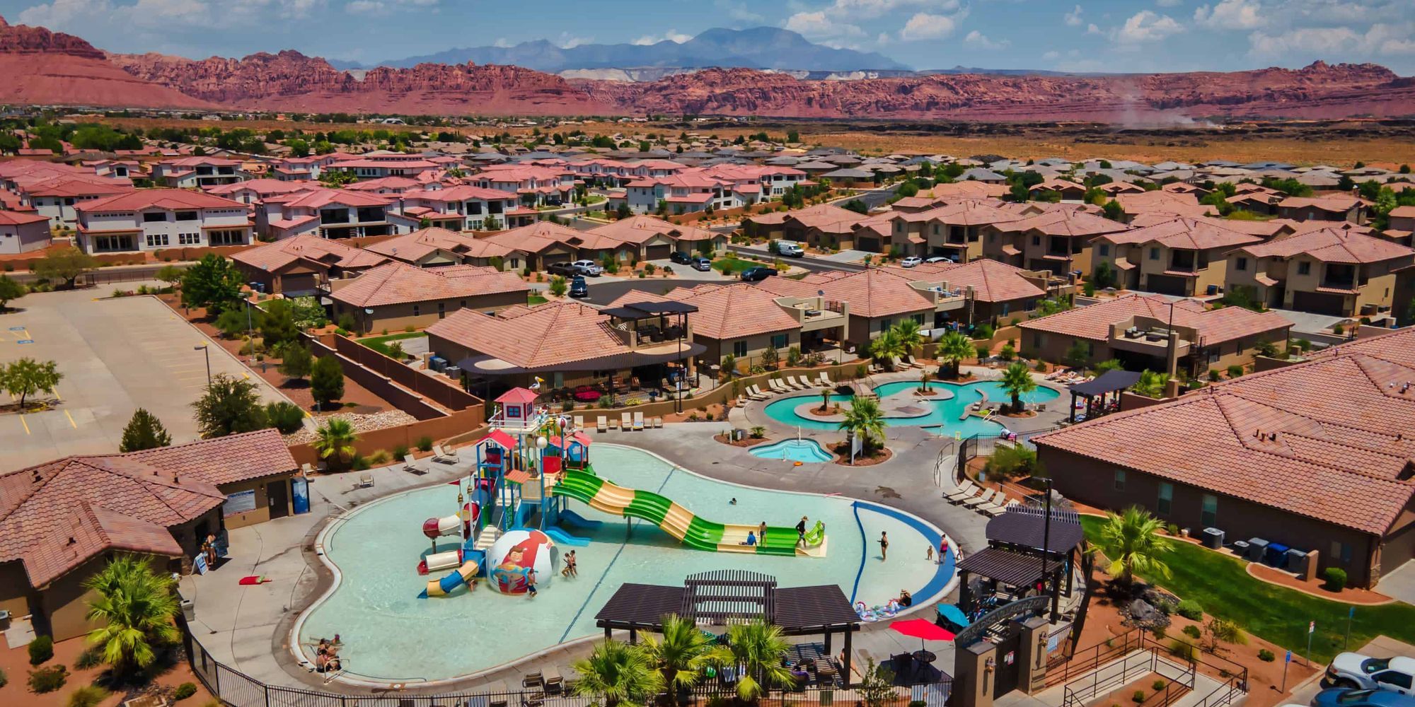 A private pool framed by palm trees and lounge chairs reflects a calm blue sky. This image highlights the comfort and high standards that make The 100 Collection properties stand out.