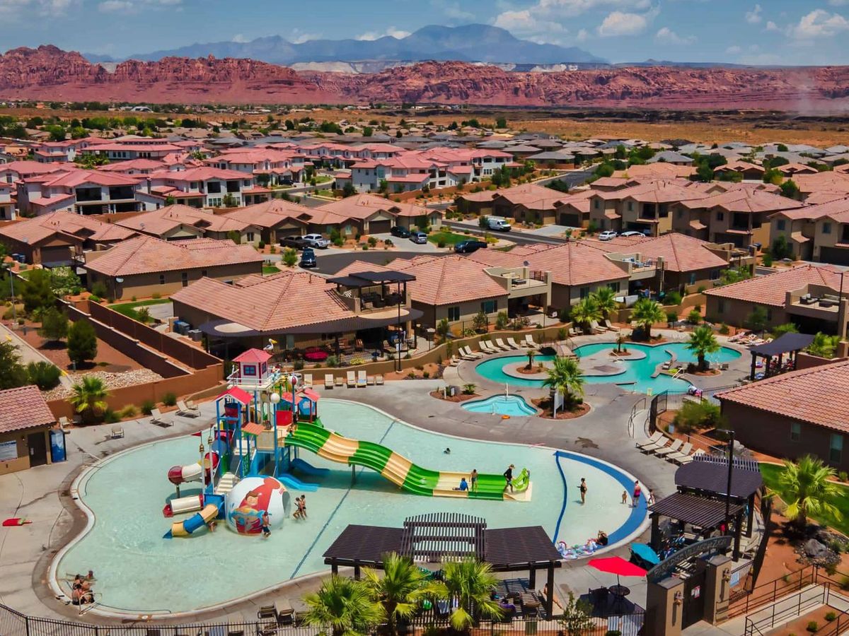 A private pool framed by palm trees and lounge chairs reflects a calm blue sky. This image highlights the comfort and high standards that make The 100 Collection properties stand out.