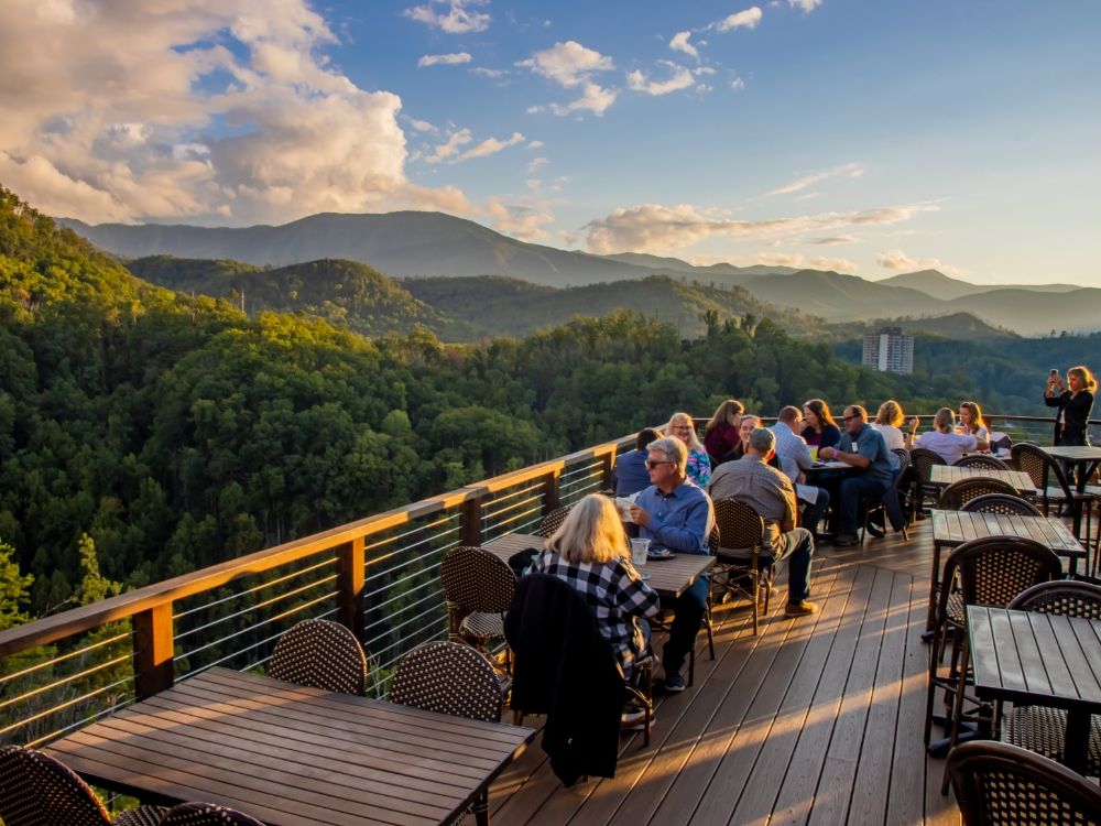 Guests take in the colorful sunset views from the top of the AnaVista Tower surrounded by mountain scenery and glowing evening skies. This scenic lookout offers one of the best panoramic views for visitors exploring the Smoky Mountains and nearby attractions.