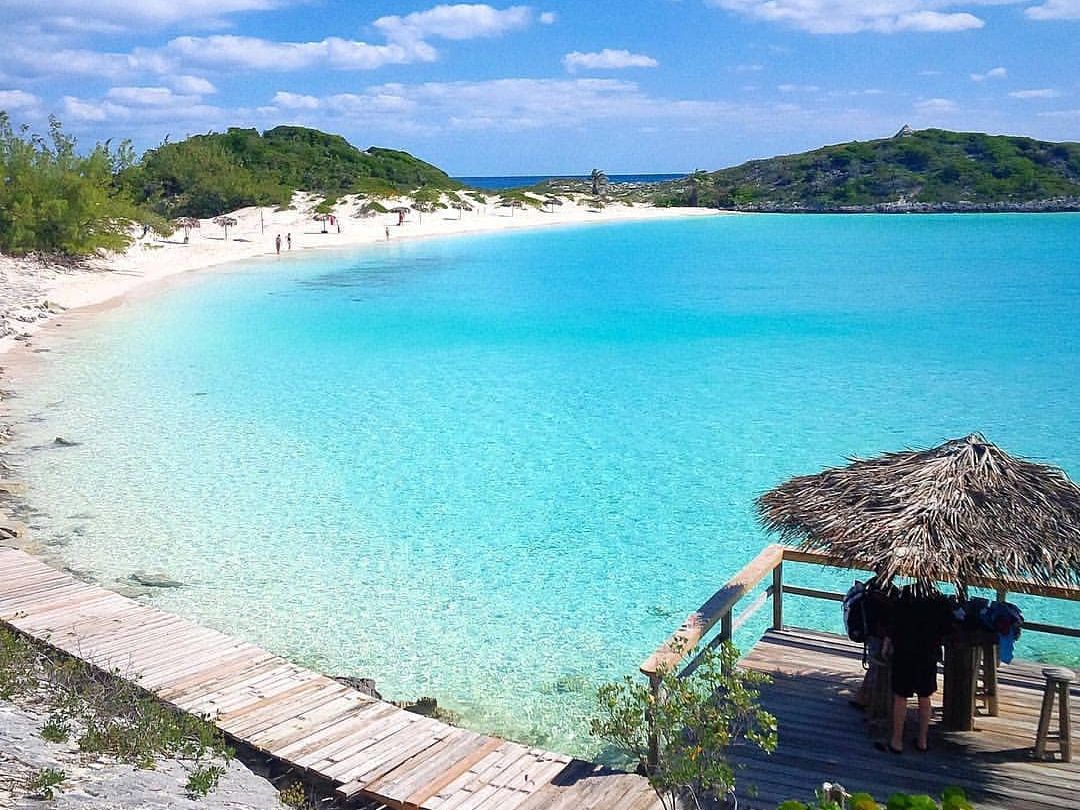 Exuma Beach showcases dazzling turquoise waters and pristine white sand, perfect for swimming or simply relaxing by the shore. A tropical paradise for beach lovers in the Bahamas.