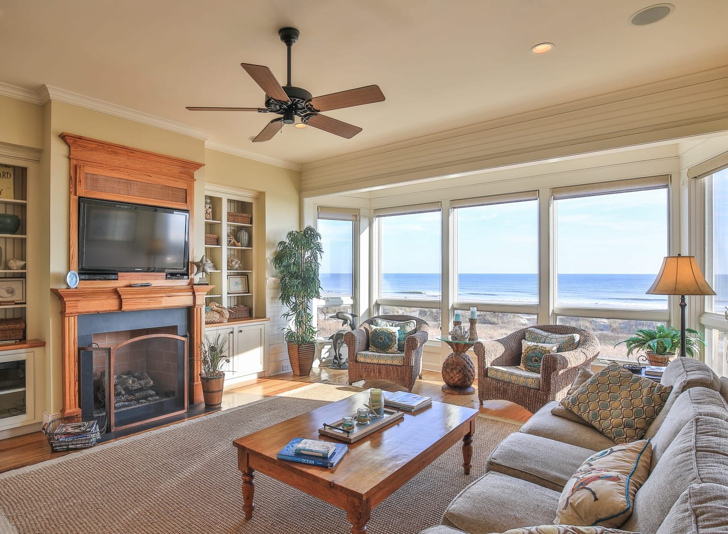 Interior of living room with dining table and large window overlooking the ocean