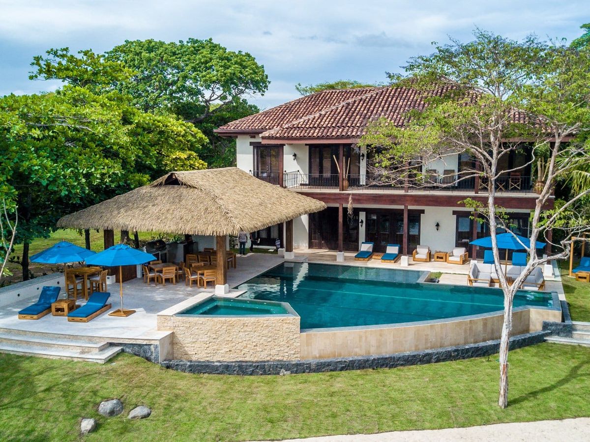 A peaceful beachfront villa with a private pool, shaded loungers, and a tropical-style outdoor bar. Perfect for families or friends looking to relax in luxury steps away from the sand.
