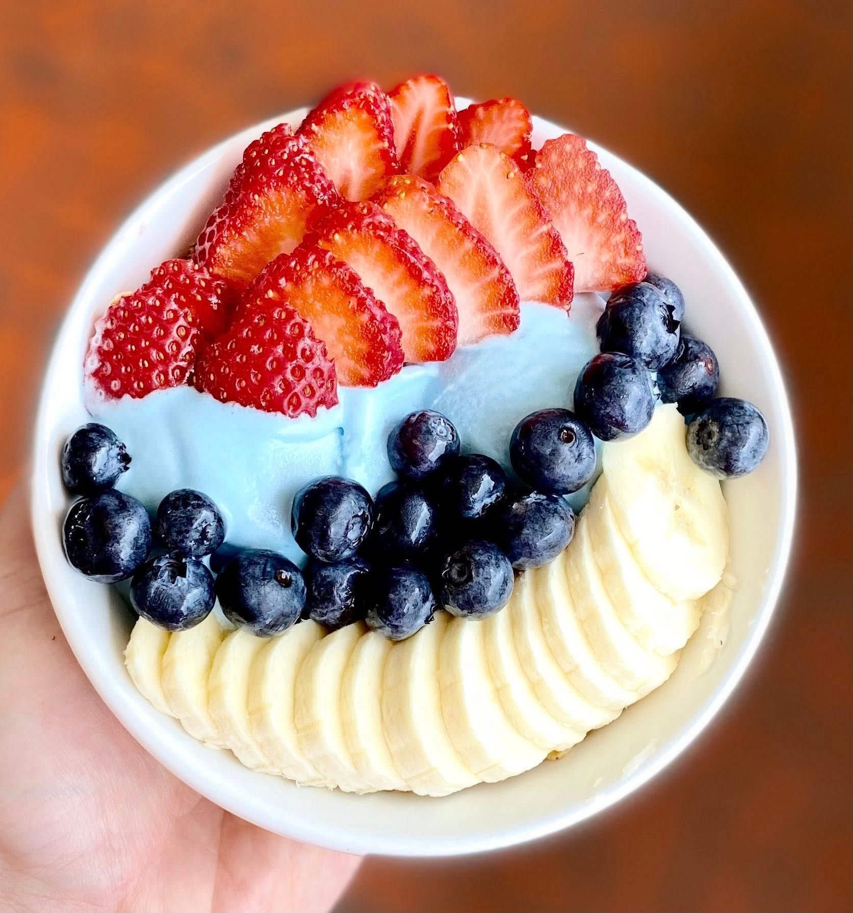 A vibrant smoothie bowl topped with fresh blueberries, strawberries, and banana slices. Its bright colors and fresh fruit make it a favorite breakfast choice for a healthy start in Blue Ridge.