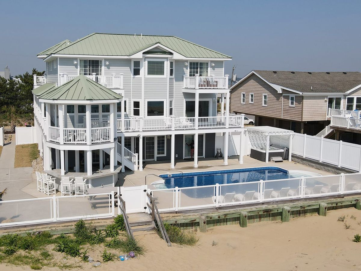 Modern beachfront estate with a sparkling pool, spacious decks, and stunning views of the coastline. A dream getaway for big family trips or group retreats.