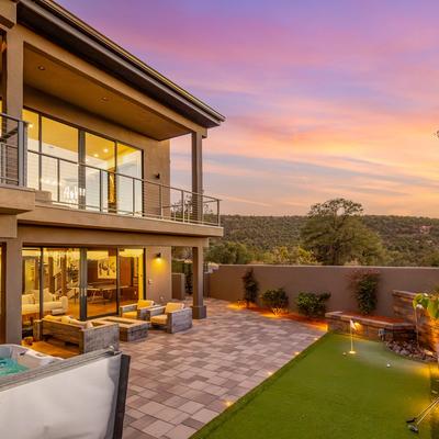 Outdoor living space with a hot tub and putting green at Zendona.